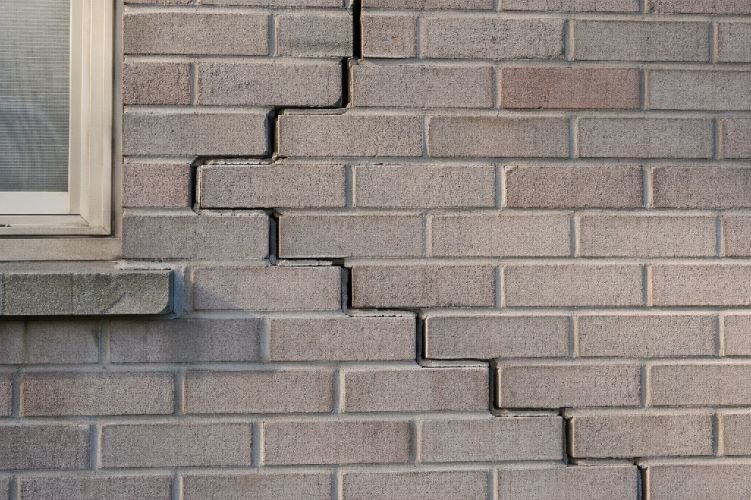 foundation settlement stair step crack brick wall exterior differential settlement sign